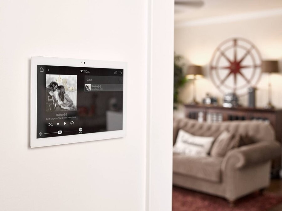 A Control4 wall panel interface showing a music streaming platform.