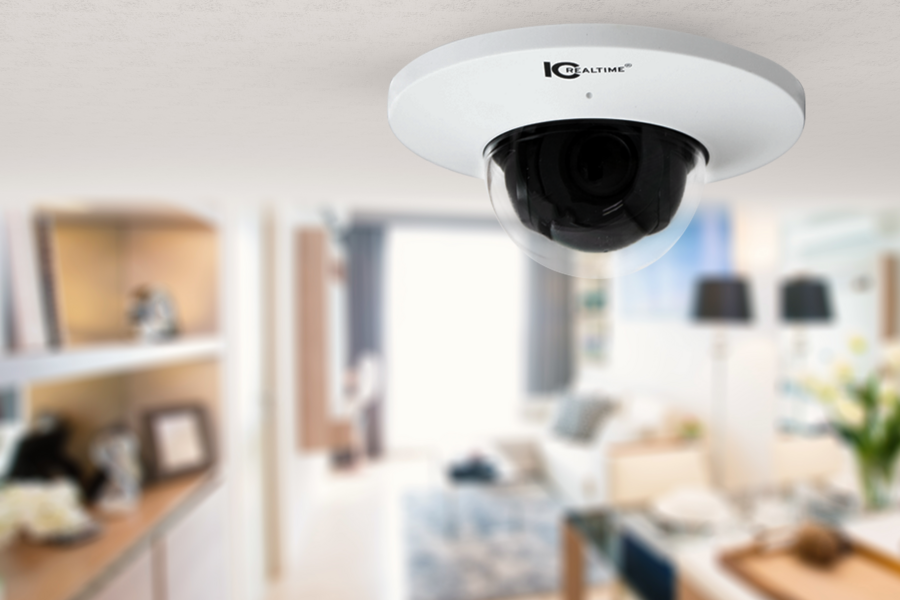 A white dome security camera mounted on the ceiling.