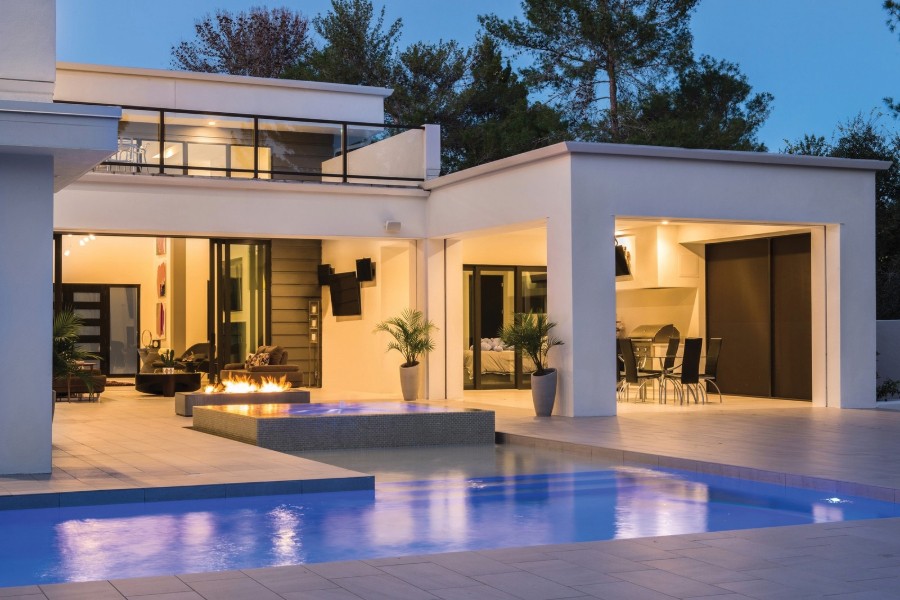 A stylish modern residence with a sparkling pool and spacious patio.