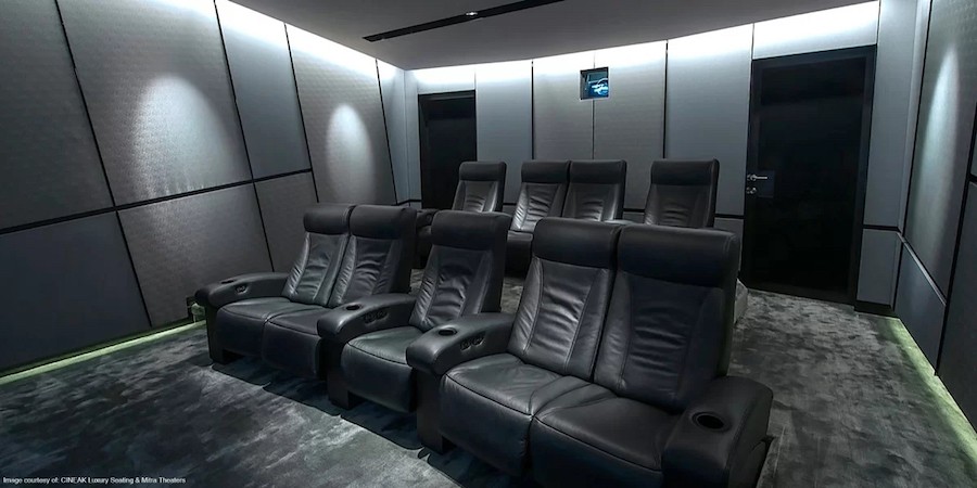A home theater setup featuring Cineak seating, a projector, and dimmable smart lighting.